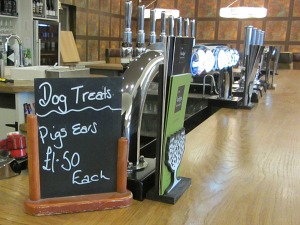 A welcome dog friendly Norfolk sign at a bar in a pub
